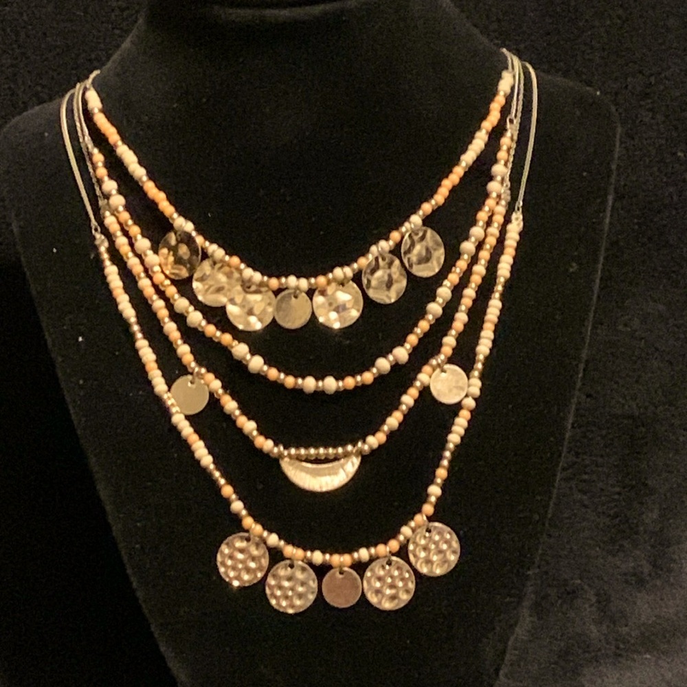 Layered gold tone necklace with beads and medallions
